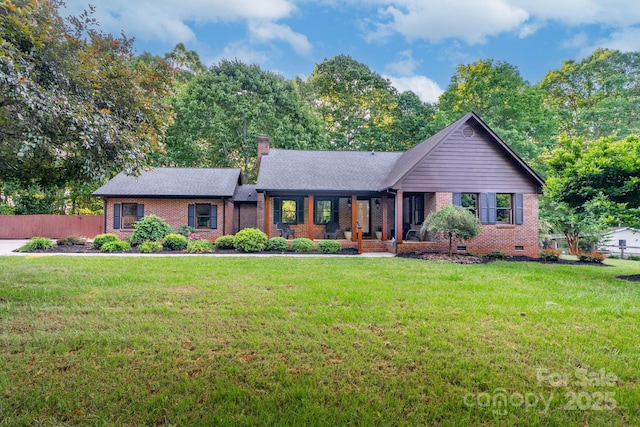 single story home with fence, a chimney, a front yard, and brick siding