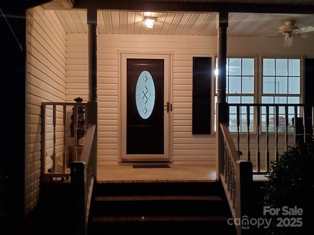 doorway to property featuring a ceiling fan