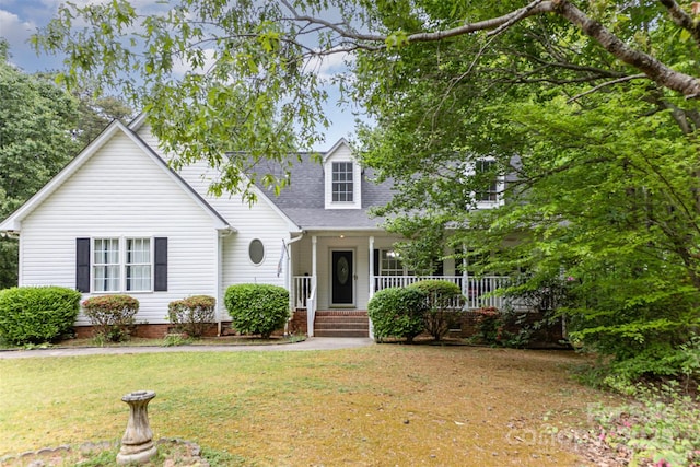 cape cod home featuring a porch, a front lawn, a shingled roof, and crawl space