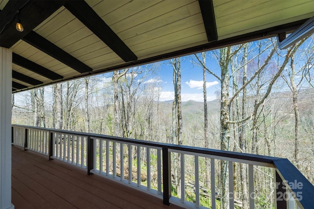 wooden terrace with a view of trees