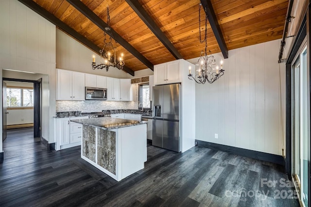 kitchen featuring dark wood-style flooring, a notable chandelier, stainless steel appliances, wooden ceiling, and a kitchen island