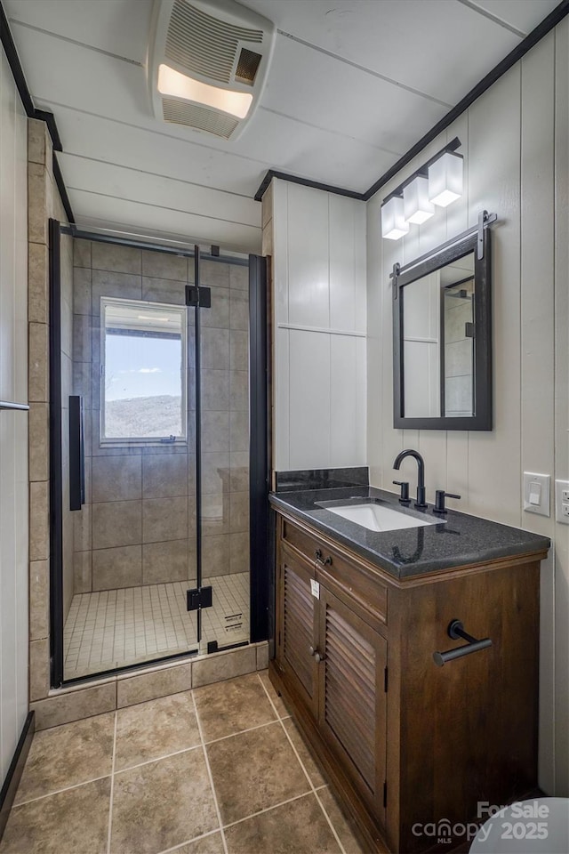 bathroom featuring visible vents, a shower stall, tile patterned flooring, and vanity