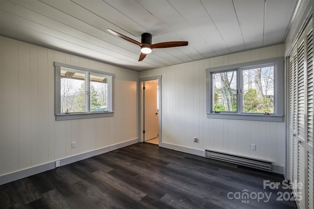 unfurnished bedroom with baseboards, dark wood finished floors, and baseboard heating