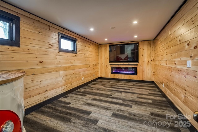 interior space featuring wooden walls, recessed lighting, and dark wood-type flooring