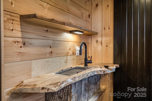 interior space with wood walls and a sink