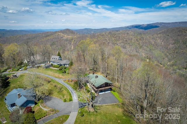 bird's eye view with a mountain view and a forest view