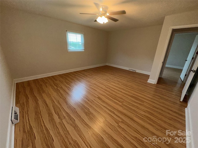 396 Pitts School Rd NW, Concord, NC 28027 - empty room with wood finished floors and a ceiling fan