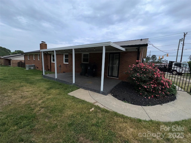 396 Pitts School Rd NW, Concord, NC 28027 - back of house with brick siding, a chimney, and a patio area