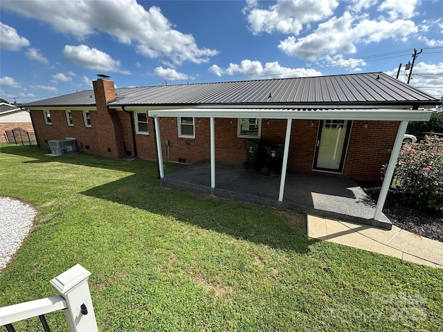 396 Pitts School Rd NW, Concord, NC 28027 - back of house with a metal roof, a lawn, a patio, and brick siding