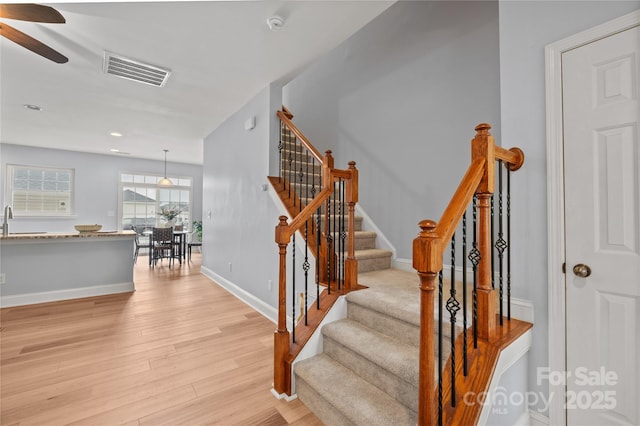 233 E Waterlynn Rd Unit B, Mooresville, NC 28117 - stairway featuring a ceiling fan and wood finished floors