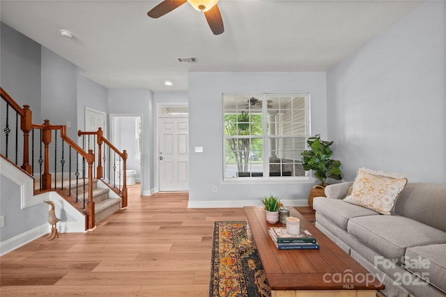 233 E Waterlynn Rd Unit B, Mooresville, NC 28117 - living room featuring stairway, ceiling fan, and light wood-type flooring