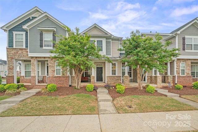 233 E Waterlynn Rd Unit B, Mooresville, NC 28117 - view of property featuring a porch, stone siding, and a front lawn