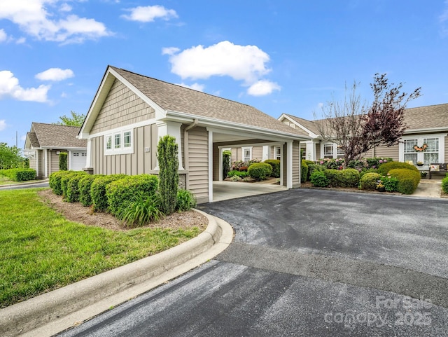 5802 Wood Duck Way, Hendersonville, NC 28792 - view of home's exterior with board and batten siding, driveway, an attached carport, and a shingled roof