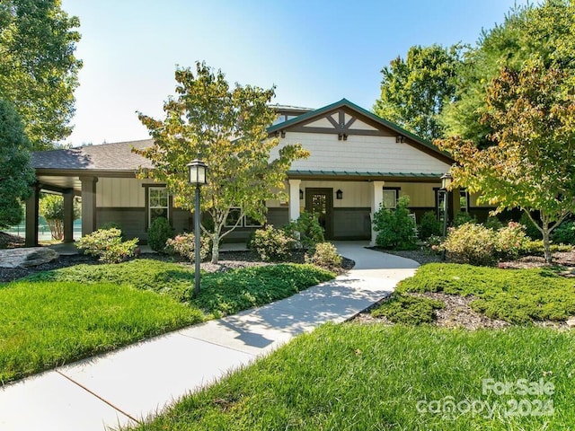 5802 Wood Duck Way, Hendersonville, NC 28792 - view of front of home with a front lawn and board and batten siding