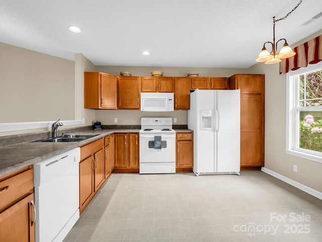 5802 Wood Duck Way, Hendersonville, NC 28792 - kitchen with white appliances, a sink, brown cabinets, recessed lighting, and pendant lighting