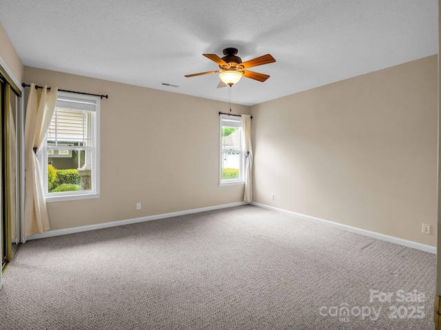 5802 Wood Duck Way, Hendersonville, NC 28792 - unfurnished room with carpet floors, ceiling fan, baseboards, and a textured ceiling