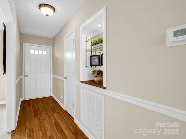 5802 Wood Duck Way, Hendersonville, NC 28792 - doorway with wood finished floors and baseboards