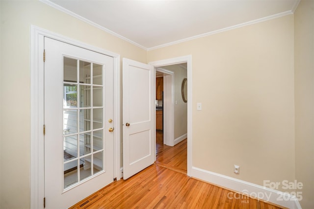 2125 Chatham Ave, Charlotte, NC 28205 - spare room featuring baseboards, ornamental molding, visible vents, and light wood-type flooring
