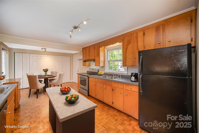 2125 Chatham Ave, Charlotte, NC 28205 - kitchen with brown cabinetry, a kitchen island, appliances with stainless steel finishes, a sink, and ornamental molding