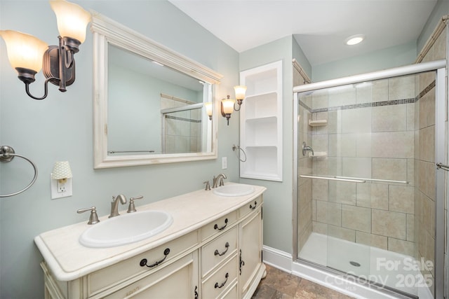 2125 Chatham Ave, Charlotte, NC 28205 - bathroom with double vanity, baseboards, a shower stall, and a sink