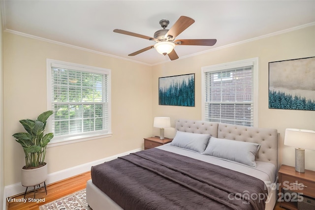 2125 Chatham Ave, Charlotte, NC 28205 - bedroom featuring crown molding, baseboards, wood finished floors, and multiple windows