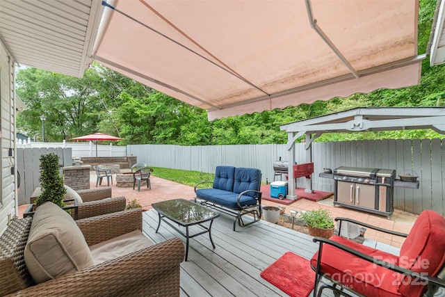wooden deck featuring area for grilling, outdoor lounge area, outdoor dining area, and a fenced backyard
