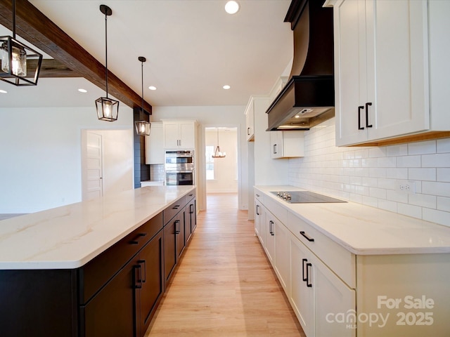 1706 Ruben Rd, Monroe, NC 28112 - kitchen featuring recessed lighting, custom exhaust hood, light wood-style flooring, light stone counters, and backsplash
