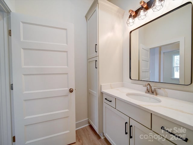 1706 Ruben Rd, Monroe, NC 28112 - bathroom with baseboards, wood finished floors, and vanity