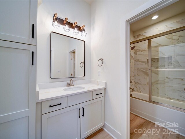 1706 Ruben Rd, Monroe, NC 28112 - full bathroom with recessed lighting, combined bath / shower with glass door, wood finished floors, and vanity