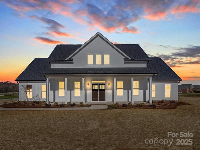 1706 Ruben Rd, Monroe, NC 28112 - back of house with a lawn, covered porch, and a shingled roof