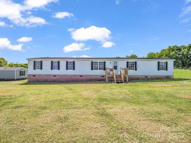 manufactured / mobile home with a front lawn and crawl space