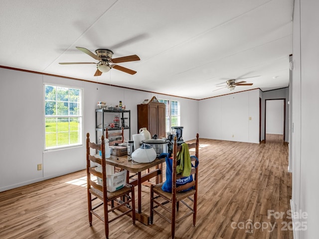 dining area featuring baseboards, a ceiling fan, wood finished floors, and ornamental molding