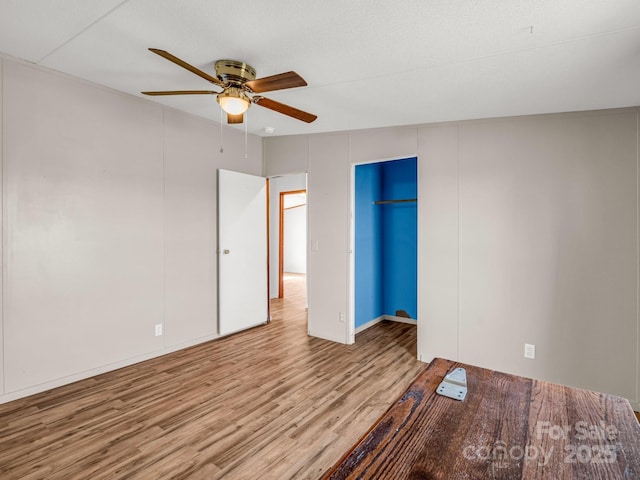 unfurnished bedroom featuring a ceiling fan and wood finished floors