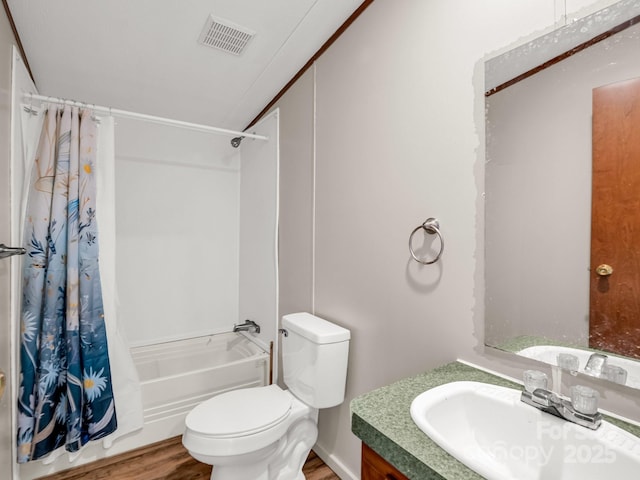 bathroom featuring shower / bath combo, vanity, toilet, wood finished floors, and visible vents