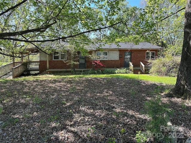 rear view of house with brick siding