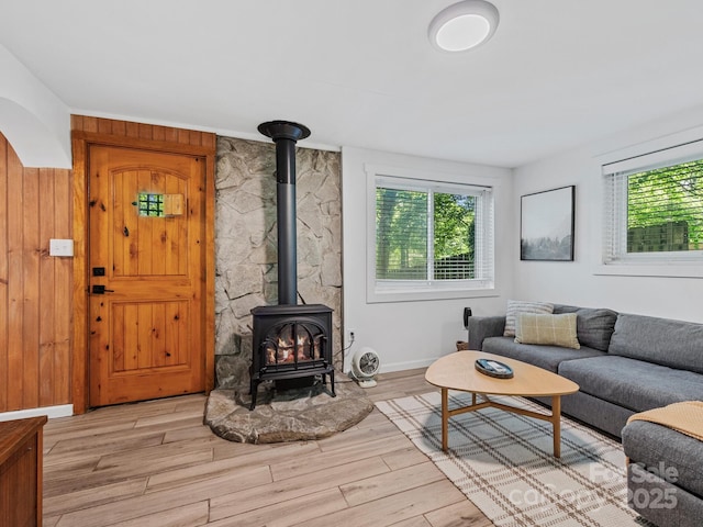 24 Iroquois St, Black Mountain, NC 28711 - living area with a wood stove, light wood-style flooring, and baseboards