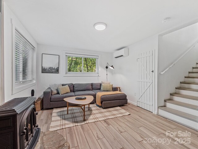 24 Iroquois St, Black Mountain, NC 28711 - living area featuring a wall mounted air conditioner, light wood finished floors, and stairs
