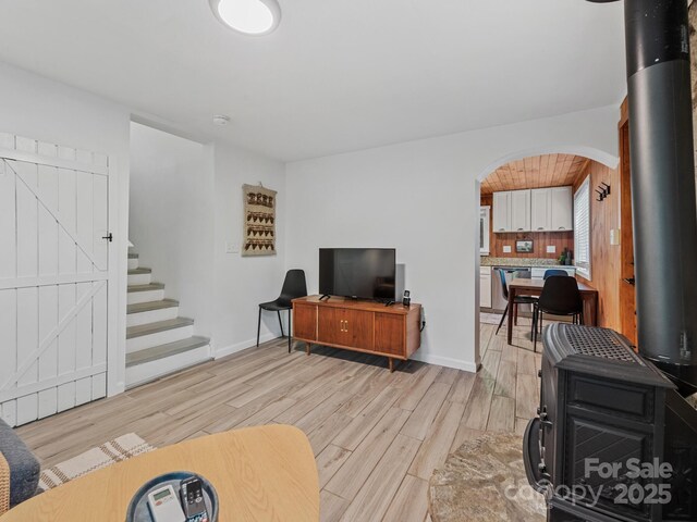 24 Iroquois St, Black Mountain, NC 28711 - living area with arched walkways, light wood finished floors, stairs, and baseboards