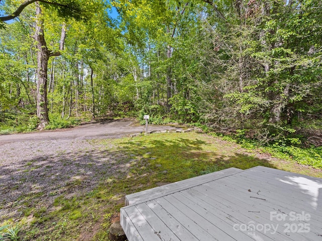 24 Iroquois St, Black Mountain, NC 28711 - view of yard featuring a deck and a wooded view