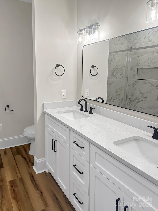 420 Fulton Dr, Kings Mountain, NC 28086 - bathroom featuring a marble finish shower, wood finished floors, toilet, and double vanity