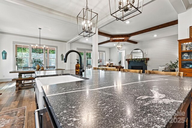 kitchen with recessed lighting, open floor plan, a notable chandelier, and beamed ceiling
