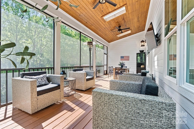 wooden terrace with outdoor dining area, ceiling fan, and outdoor lounge area