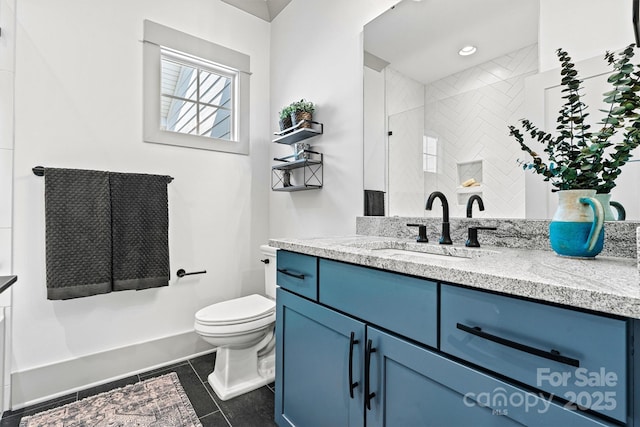 full bath featuring toilet, tile patterned floors, tiled shower, and vanity