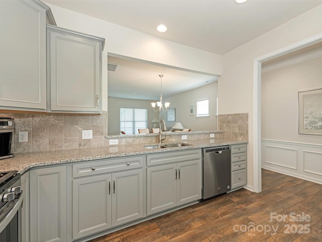 1026 Kirby Dr, Fort Mill, SC 29715 - kitchen with stainless steel appliances, a sink, gray cabinetry, dark wood-style flooring, and a chandelier