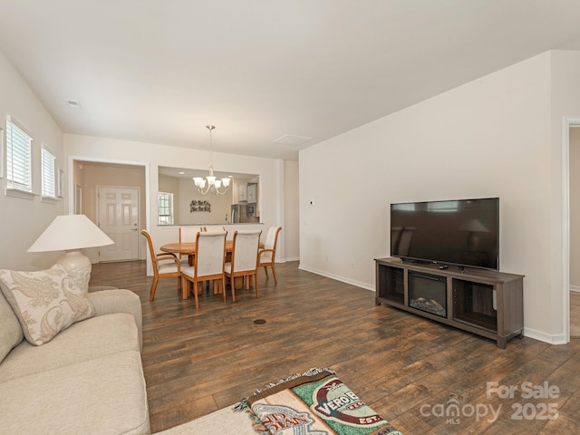 1026 Kirby Dr, Fort Mill, SC 29715 - living area featuring a chandelier, dark wood-style flooring, and baseboards