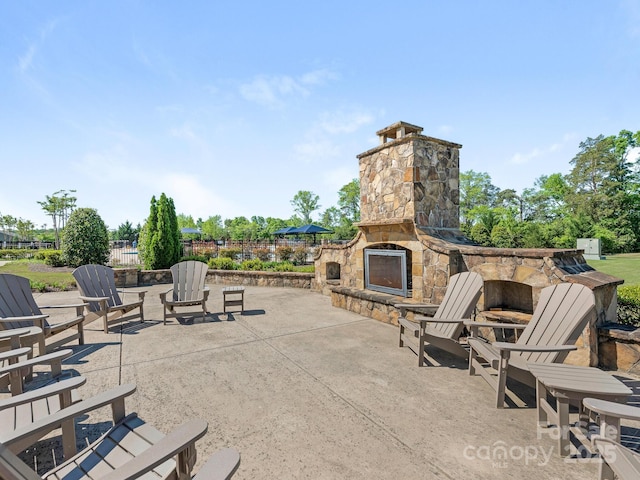 1026 Kirby Dr, Fort Mill, SC 29715 - view of patio / terrace with an outdoor stone fireplace and fence