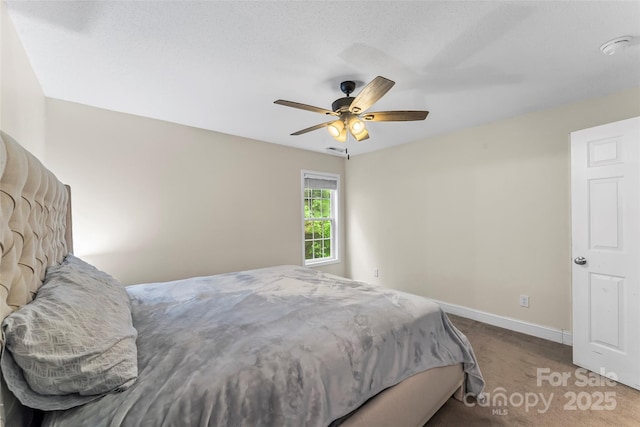 bedroom featuring carpet floors, a ceiling fan, and baseboards