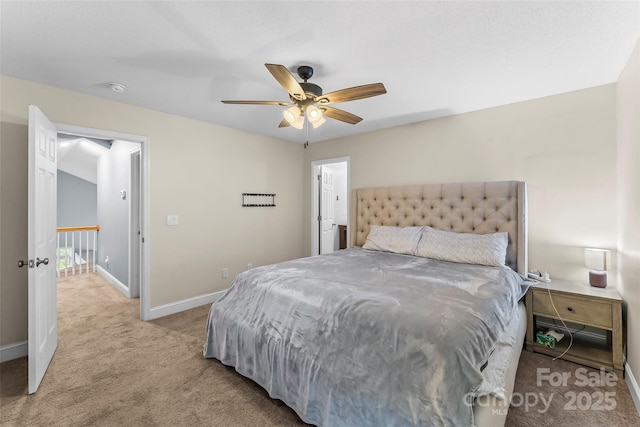bedroom with light colored carpet, baseboards, and ceiling fan