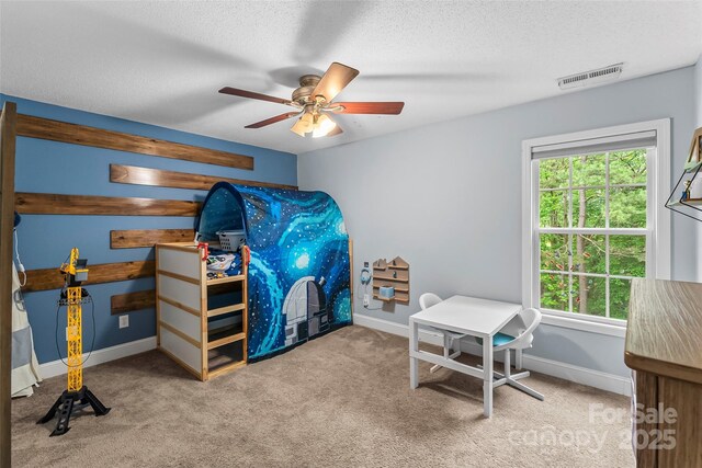 carpeted bedroom with baseboards, a ceiling fan, a textured ceiling, and visible vents