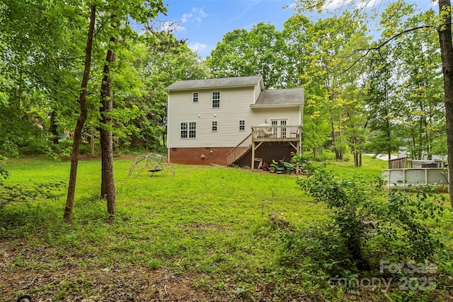 back of house with a lawn, stairway, and a deck